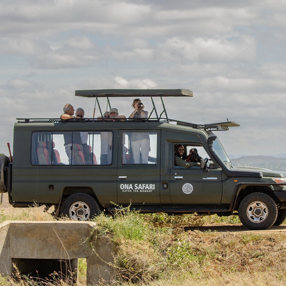 Ona Safari private vehicle with guests watching wildlife from the pop-up roof